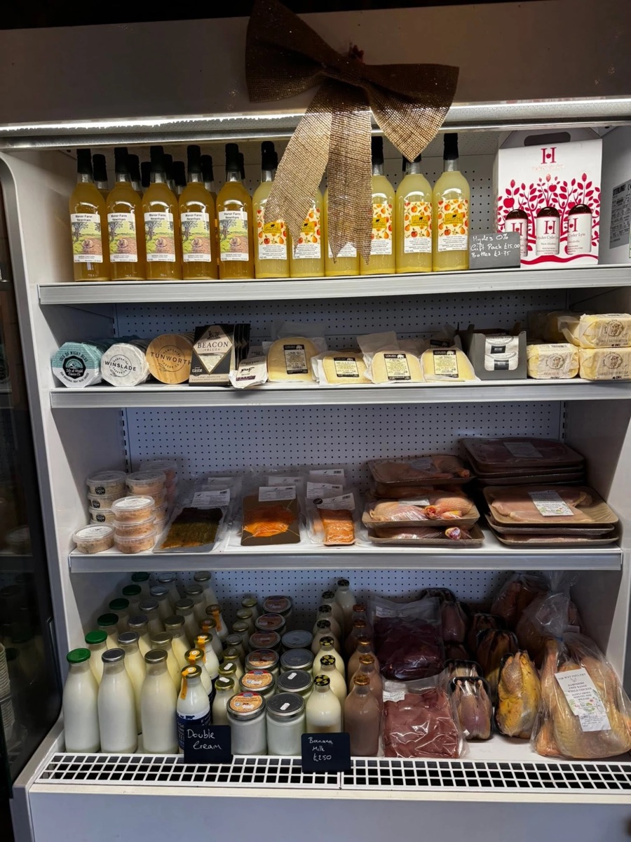 The deli fridge with local cheeses, butter, apple juice, milk and free-range poultry