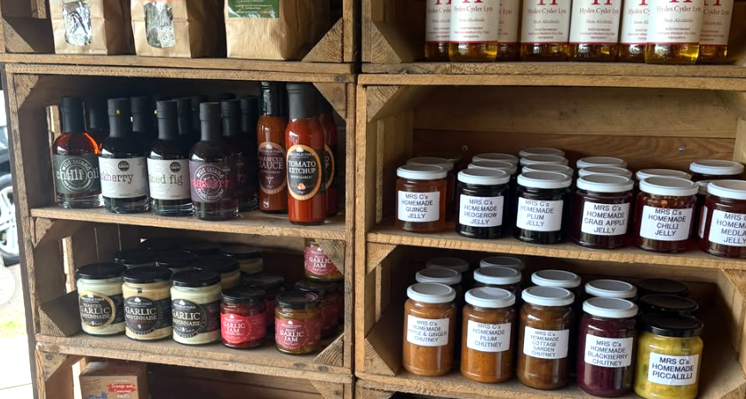 Local jams, chutneys and larder goods on wooden shelves